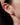 Сребърни обеци с аквамаринени фасетирани камъни на женско ухо в близък план